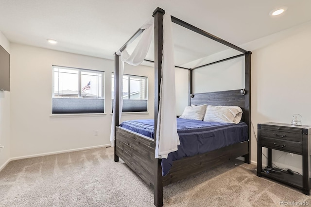 carpeted bedroom featuring baseboards and recessed lighting