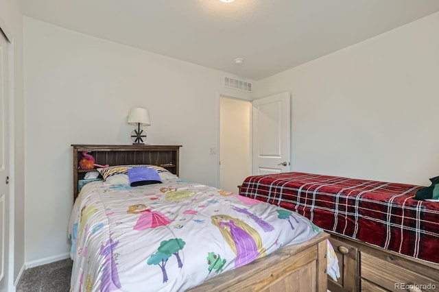 carpeted bedroom with baseboards and visible vents
