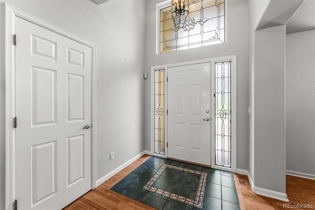 1564 S Uinta Way, Denver, CO 80231 - entrance foyer with baseboards, wood finished floors, and a textured wall