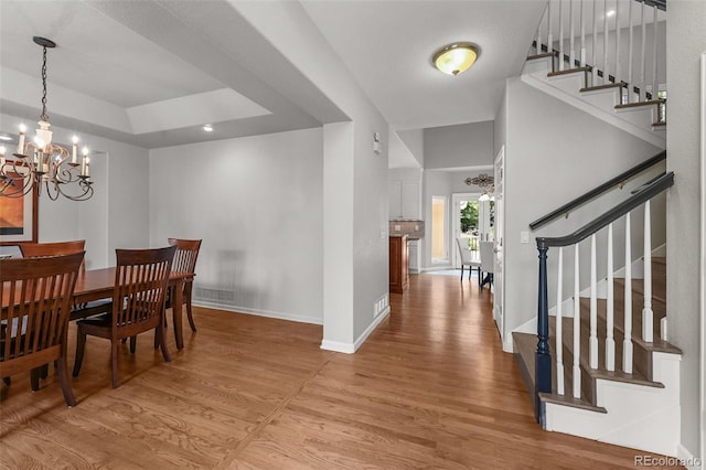1564 S Uinta Way, Denver, CO 80231 - dining room featuring a chandelier, light wood finished floors, stairs, and baseboards
