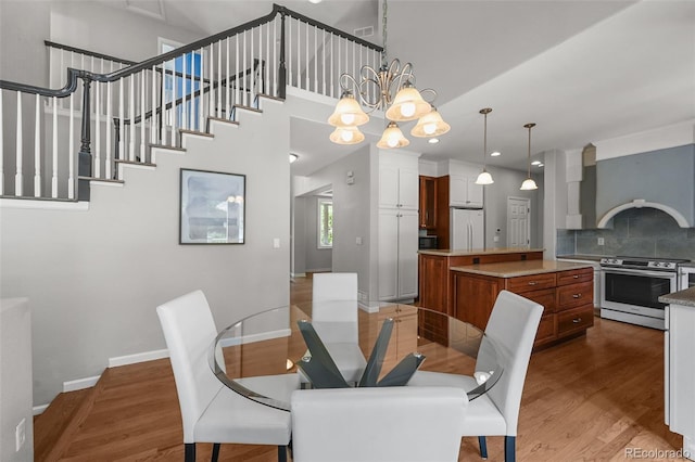 1564 S Uinta Way, Denver, CO 80231 - dining room featuring wood finished floors, baseboards, a chandelier, and recessed lighting