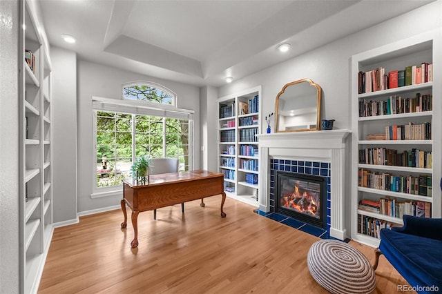 1564 S Uinta Way, Denver, CO 80231 - office with wood finished floors, built in features, a tiled fireplace, a tray ceiling, and baseboards