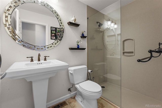 1564 S Uinta Way, Denver, CO 80231 - full bathroom with toilet, a walk in shower, tile patterned floors, and baseboards