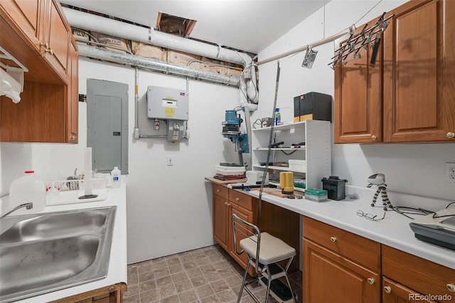 1564 S Uinta Way, Denver, CO 80231 - kitchen featuring a sink, electric panel, light countertops, and brown cabinetry