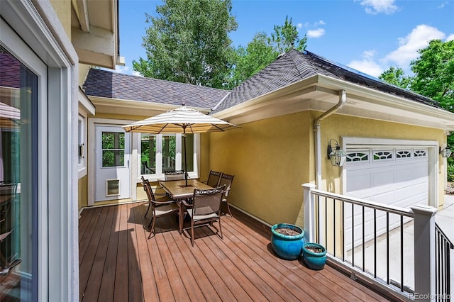 1564 S Uinta Way, Denver, CO 80231 - wooden terrace featuring outdoor dining area and an attached garage