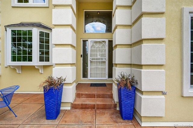 1564 S Uinta Way, Denver, CO 80231 - doorway to property with stucco siding
