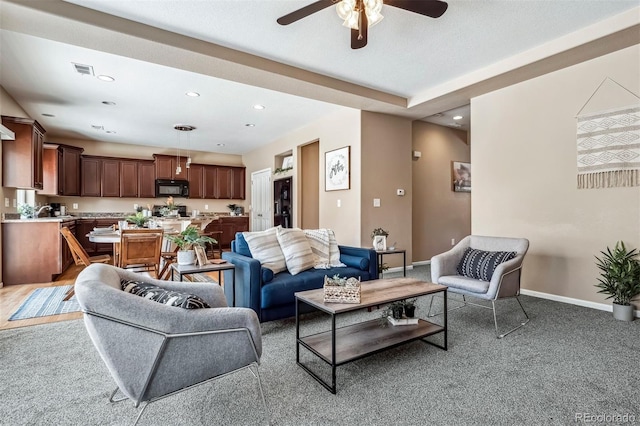 living area with a ceiling fan, visible vents, baseboards, recessed lighting, and light colored carpet