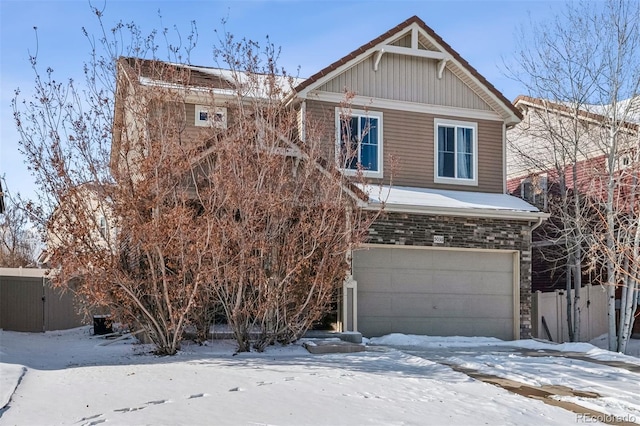 view of front of property with an attached garage and fence