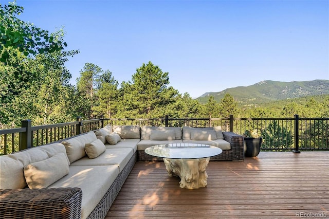 2873 Cortina Ln, Evergreen, CO 80439 - wooden deck featuring outdoor lounge area and a mountain view