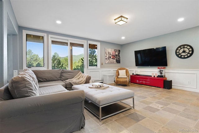 2873 Cortina Ln, Evergreen, CO 80439 - living room with a decorative wall, recessed lighting, stone tile floors, and wainscoting