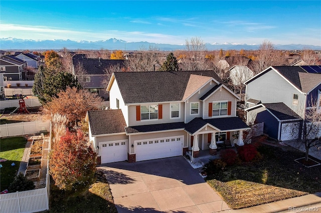 view of front of home with a garage and a mountain view