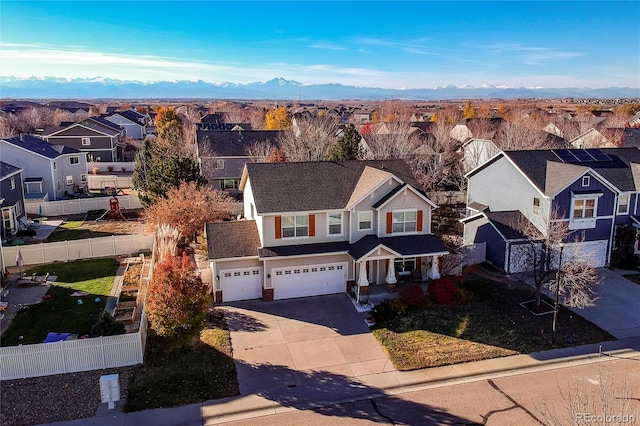 view of front facade with a mountain view and a garage