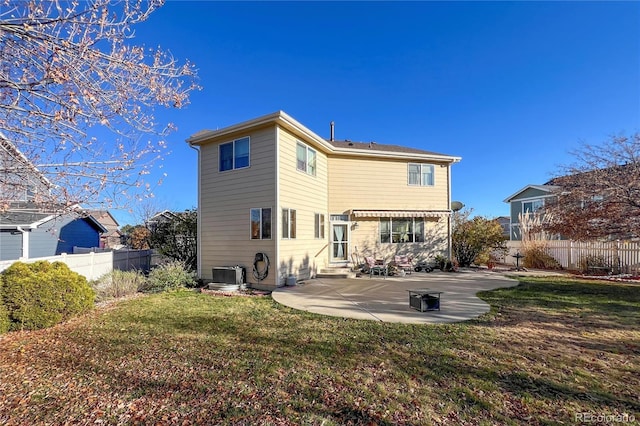 rear view of house featuring a patio, a yard, and central AC unit