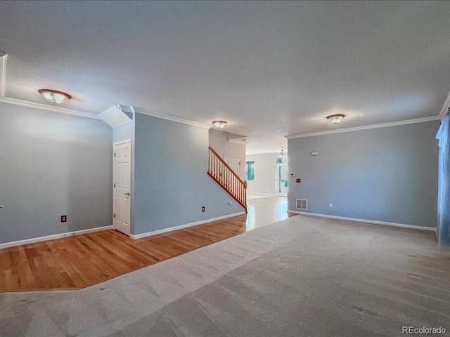 carpeted spare room with crown molding