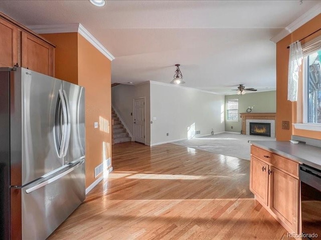 kitchen featuring crown molding, light hardwood / wood-style flooring, stainless steel refrigerator, ceiling fan, and beverage cooler