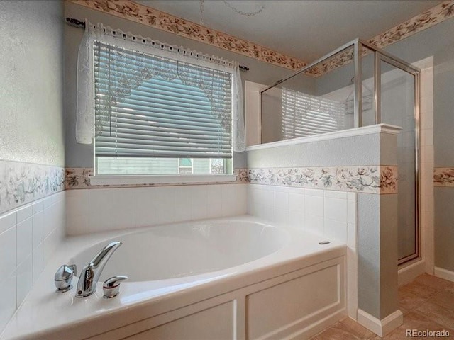 bathroom with tile patterned floors and independent shower and bath