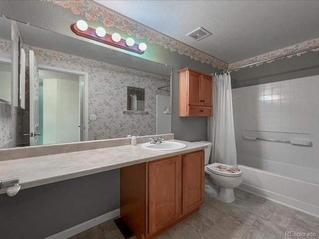 full bathroom featuring vanity, toilet, a textured ceiling, and shower / bath combo with shower curtain