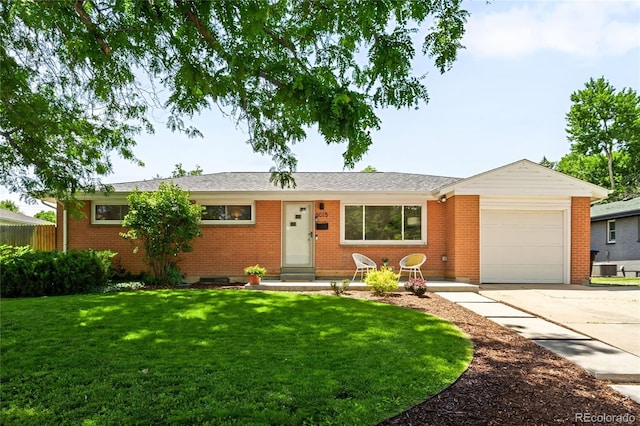6015 Everett St, Arvada, CO 80004 - ranch-style house with an attached garage, driveway, and brick siding