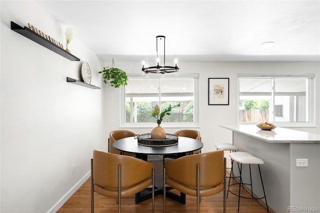 6015 Everett St, Arvada, CO 80004 - dining space featuring wood finished floors and a chandelier