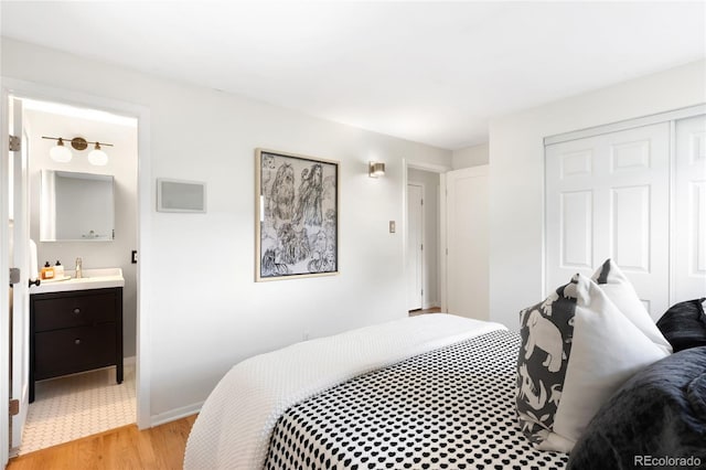 6015 Everett St, Arvada, CO 80004 - bedroom with light wood-type flooring, wet bar, a closet, and ensuite bath
