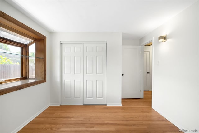 6015 Everett St, Arvada, CO 80004 - unfurnished bedroom featuring light wood finished floors and a closet