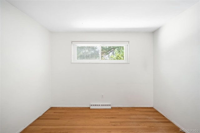 6015 Everett St, Arvada, CO 80004 - spare room featuring light wood finished floors and a baseboard radiator