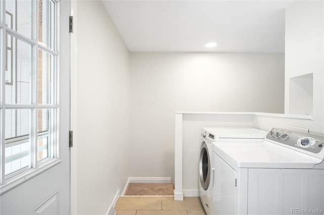 6015 Everett St, Arvada, CO 80004 - laundry room featuring washing machine and dryer and light tile patterned flooring