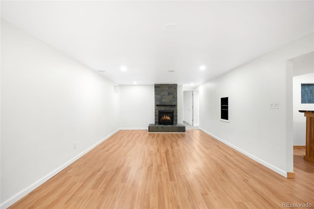 6015 Everett St, Arvada, CO 80004 - unfurnished living room with a fireplace, light wood-style floors, and recessed lighting