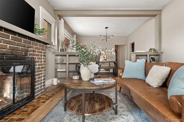 3725 Federal Blvd, Denver, CO 80211 - living room with a brick fireplace, wood finished floors, and a chandelier