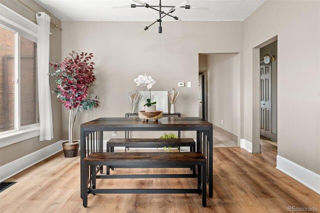 3725 Federal Blvd, Denver, CO 80211 - dining room with a chandelier and light wood-type flooring