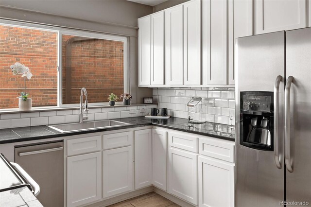 3725 Federal Blvd, Denver, CO 80211 - kitchen with stainless steel appliances, tasteful backsplash, dark countertops, and white cabinets