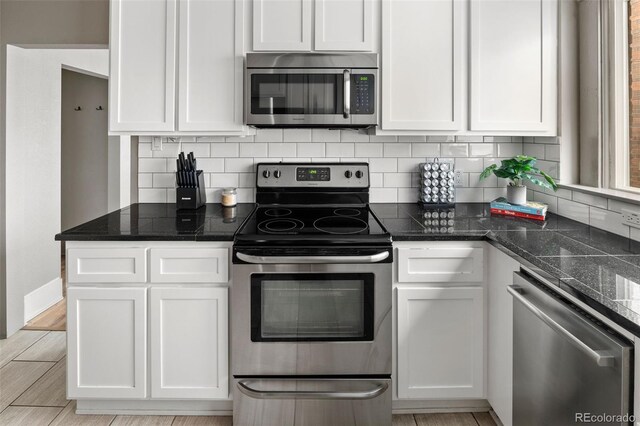 3725 Federal Blvd, Denver, CO 80211 - kitchen featuring appliances with stainless steel finishes, white cabinetry, and decorative backsplash