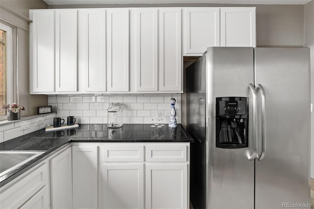 3725 Federal Blvd, Denver, CO 80211 - kitchen featuring stainless steel fridge, white cabinetry, tasteful backsplash, and dark countertops