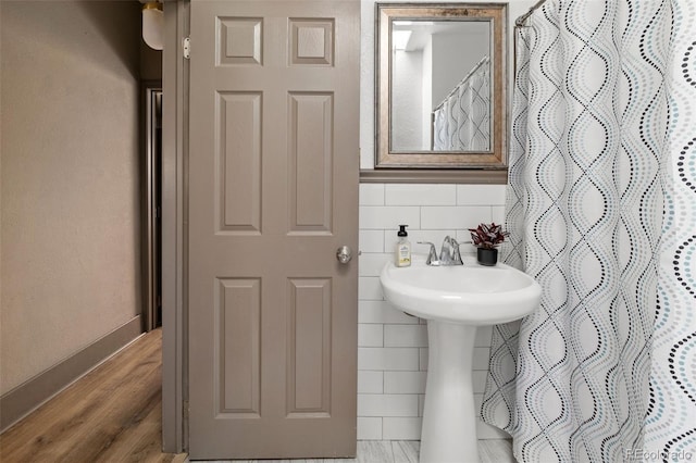3725 Federal Blvd, Denver, CO 80211 - bathroom with a shower with shower curtain, tile walls, and wood finished floors