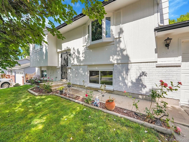13246 Deneb Dr, Lone Tree, CO 80124 - view of home's exterior with brick siding and a yard