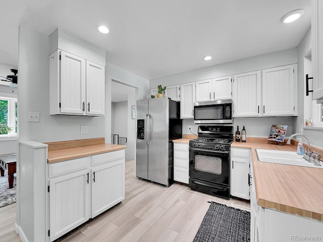 13246 Deneb Dr, Lone Tree, CO 80124 - kitchen with stainless steel appliances, light wood-style floors, white cabinetry, and recessed lighting