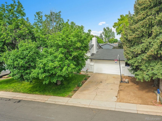 13246 Deneb Dr, Lone Tree, CO 80124 - view of property hidden behind natural elements featuring driveway, a garage, and roof with shingles