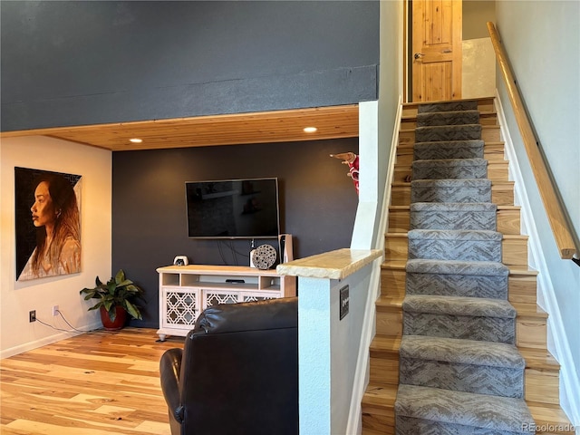 stairs featuring hardwood / wood-style floors