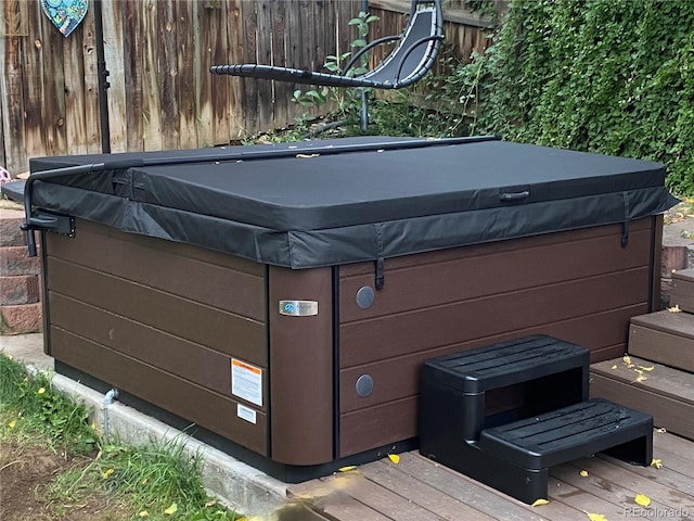 wooden deck with a hot tub