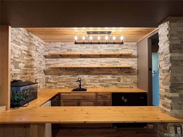 bar with wood ceiling, wooden counters, and sink