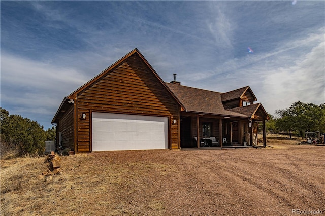 view of front facade featuring central air condition unit, an attached garage, and driveway