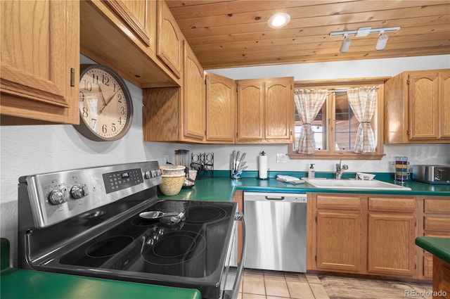 kitchen featuring light tile patterned floors, lofted ceiling, a sink, wood ceiling, and appliances with stainless steel finishes