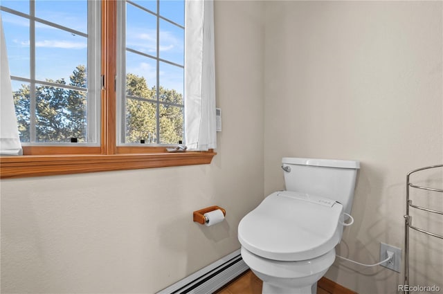 bathroom with toilet and a baseboard radiator