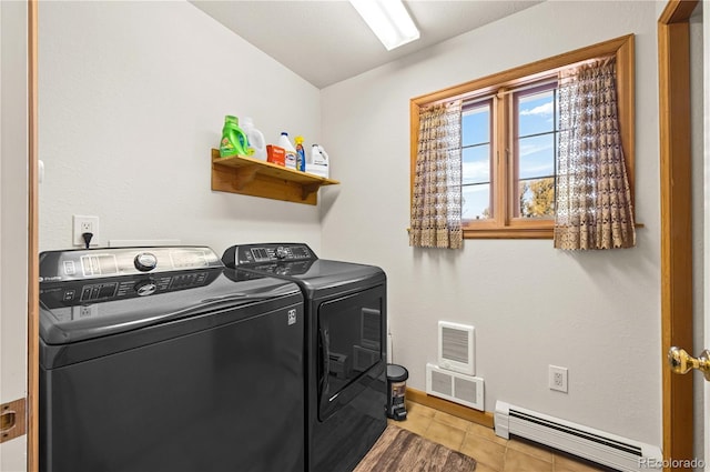 clothes washing area with a baseboard radiator, visible vents, washing machine and dryer, and laundry area