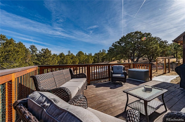 wooden terrace with an outdoor living space