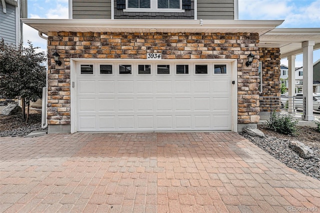3934 N Quatar Ct, Aurora, CO 80019 - garage featuring decorative driveway