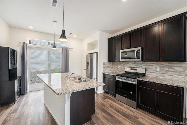 3934 N Quatar Ct, Aurora, CO 80019 - kitchen with stainless steel appliances, backsplash, dark wood-style flooring, and recessed lighting