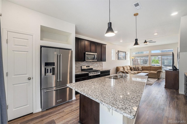 3934 N Quatar Ct, Aurora, CO 80019 - kitchen featuring stainless steel appliances, open floor plan, dark brown cabinets, dark wood-style floors, and ceiling fan