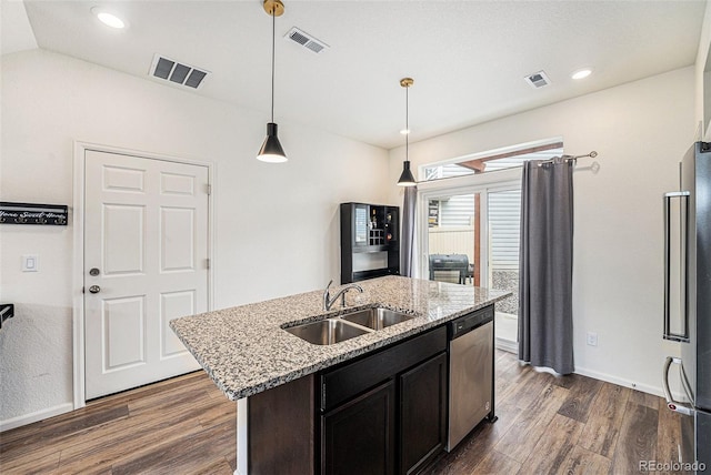 3934 N Quatar Ct, Aurora, CO 80019 - kitchen featuring appliances with stainless steel finishes, dark wood-type flooring, a kitchen island with sink, light stone countertops, and pendant lighting