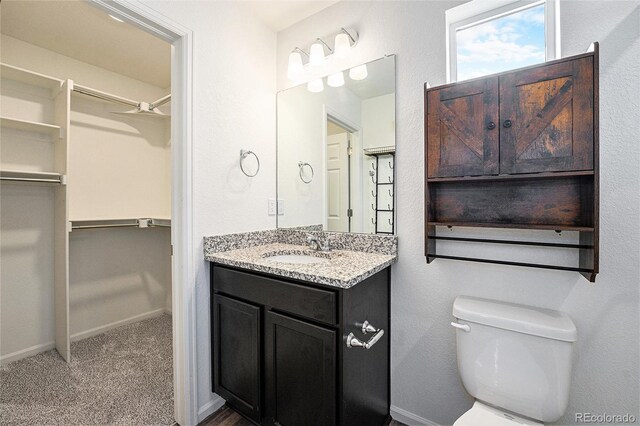 3934 N Quatar Ct, Aurora, CO 80019 - bathroom with vanity and a walk in closet